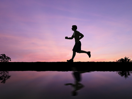 silhouette man jogging with twilight sky backgroundの写真素材