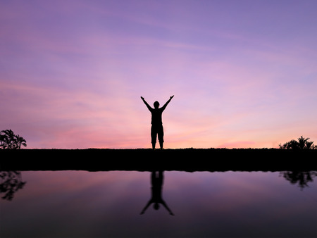 silhouette man open arms standing aloneの写真素材