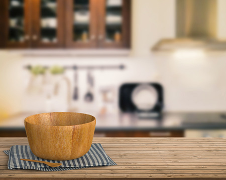 3d rendering kitchenware on wooden counter with kitchen blurred backgroundの写真素材