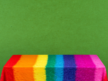 rainbow tablecloth on green backgroundの写真素材