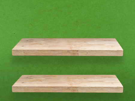 two wooden shelves on green backgroundの写真素材