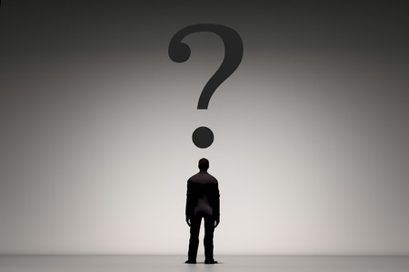 rear view of businessman standing with question markの写真素材