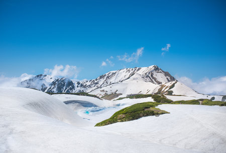 TATEYAMA, JAPAN - June 11, 2017: Japan Alps with melting snow. The Tateyama Kurobe Alpine route operate in late April until November, is one of the tourist attraction in Japan.のeditorial素材