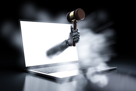 cyber law concept with 3d rendering robotic hand holding gavel judge out of notebook computerの写真素材
