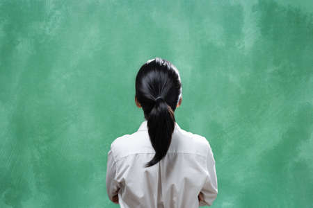 Rear view asian woman with blank blackboardの写真素材