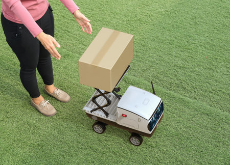 Delivery robot send cardboard box to customerの写真素材