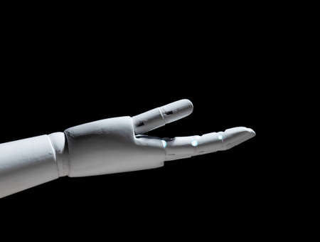 White robot hand open gesture isolated on black backgroundの写真素材