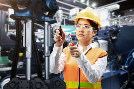 Asian engineer or technician wear safety helmet and reflective vest work in factoryの写真素材