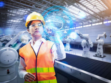 Technician or engineer work with 3d rendering robotic arms in factory