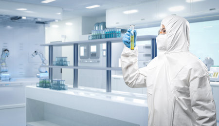 Worker wears medical protective suit or white coverall suit with test tube in laboratory