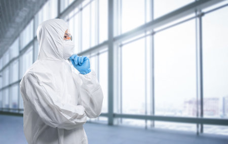 Worker wears medical protective suit or white coverall suit with mask and goggles analyzeの写真素材