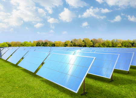 3d rendering amount of solar panels on green field or solar farm againt blue skyの写真素材