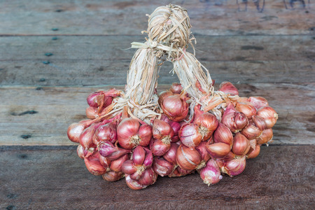 Shallot onions in a group on woodの写真素材