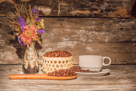 Coffee cup and vases on wooden backgroundの写真素材