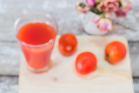 Still Life Tomato juice in grass with fresh tomato fruitsの写真素材