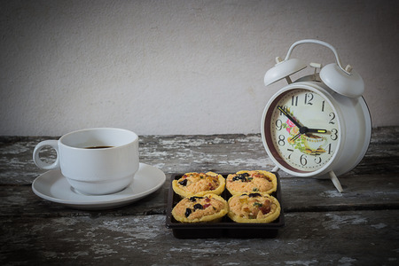 Still Life Cookies and coffee clock on wooden backgroundの写真素材