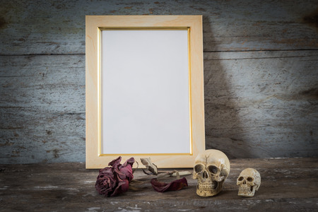 Still life with frame, skull, roses on rusty steel board backgroundの写真素材