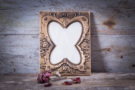 Still life with frame, roses on rusty steel board backgroundの写真素材