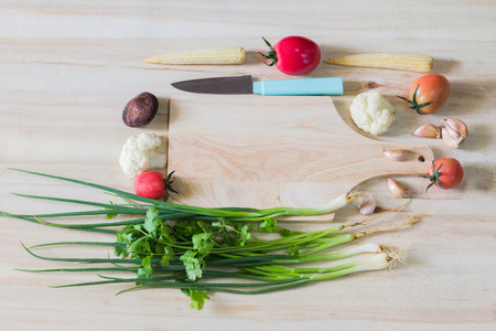Fresh ingredients for cooking in rustic setting: tomatoes, lemon, garlic and onion, letttuce.の写真素材