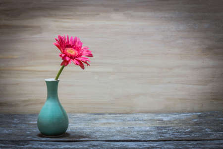 Still life vase with flowers on wood background.の写真素材