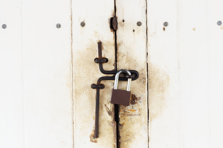 Background of door with lock in metal material and copyspace on wall.の写真素材