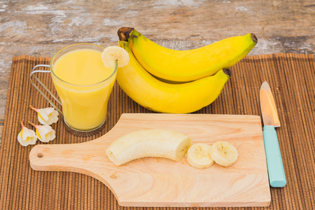 bananas and a sliced banana and banana smoothies.の写真素材