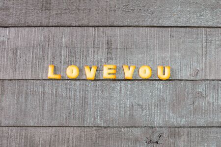 love you alphabet biscuit on wooden table, stock photoの写真素材