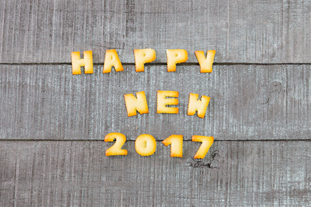 Cookies paste the text Happy New Year on the old wooden floor.
