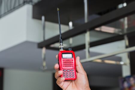 Red radio communication on working women hand