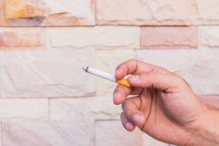 a young man smoking a cigarette
