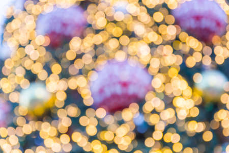 Decorated Christmas tree on sparkling light backgroundの写真素材