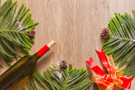 Christmas composition. Christmas gift, knitted blanket, pine cones, fir branches on woodenの写真素材