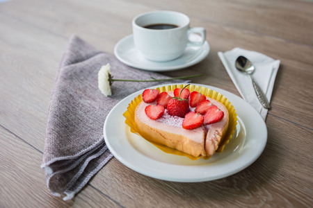 Cake and strawberries on wood background.