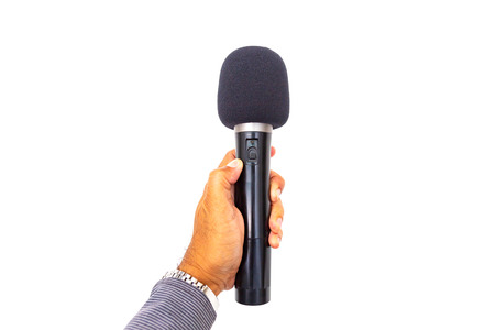 Microphone in hand on white background.の写真素材