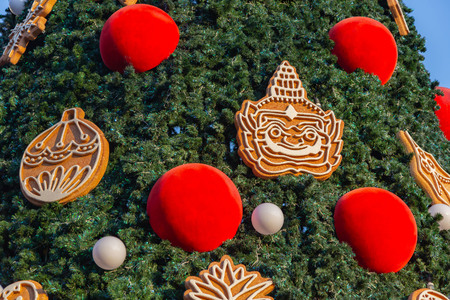 Decorated Christmas tree with gifts on a wooden background.
