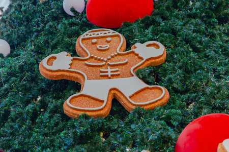 Decorated Christmas tree with gifts on a wooden background.