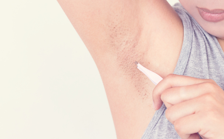 Hand young woman plucking her armpit, Healthcare and medicine concept.の写真素材