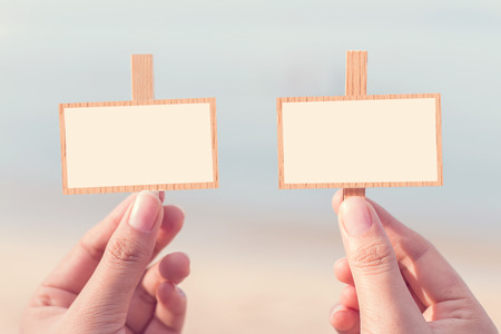 Hands of woman holding notes with space for text on the beach in the morning on weekends, Vintage style. の写真素材