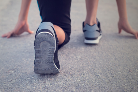 Young woman on start running position. Healthy concept.の写真素材