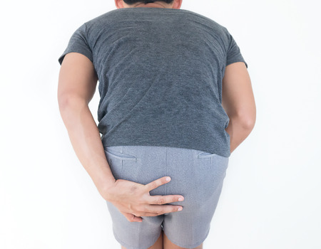 Young man has pain in the butt, Hemorrhoids, Anal disorders.の写真素材