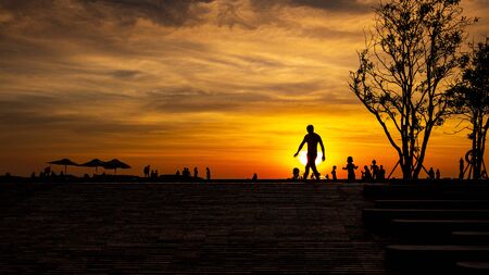 Picture of relaxation of people in the pool in resort in sunset time on summer vacation. Family holiday travel concept. Crowd of people or friend playing together in the swimming pool.の写真素材