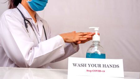 A doctor is demonstrated how to clean hand, used alcohol-gel and spray to clean hand, to protect from Coronavirus or Covid-19の写真素材