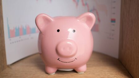 piggy bank isolate in wooden caboard. saving money for future.の写真素材