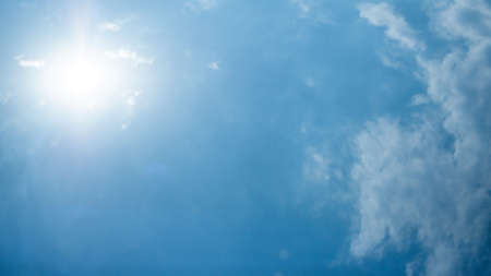 Abstract groups of puffy, and brilliant white clouds, when sunlight are height in the sky,  Stunning springtime weather.の写真素材