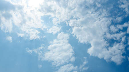 Abstract groups of puffy, and brilliant white clouds, when sunlight are height in the sky,  Stunning springtime weather.の写真素材