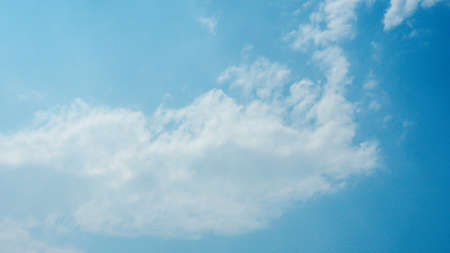 Abstract groups of puffy, and brilliant white clouds, when sunlight are height in the sky,  Stunning springtime weather.の写真素材