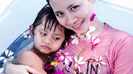 Family are relaxing in a small pool to release the heat in summer at home. Happy child, happy family, healthy family, childhood concept.の写真素材
