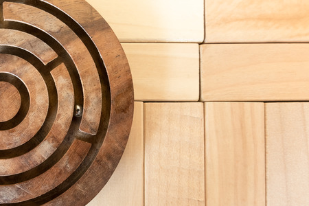 Circular maze on the wood puzzle backgroundの写真素材