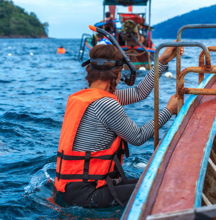 Young woman preparing to snorkel dive with life jacketの写真素材