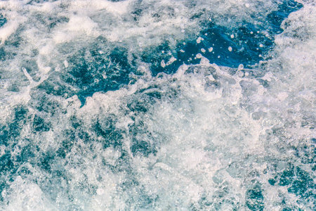 Sea waves bubble foam from boat long tail boatの写真素材